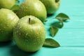 Fresh ripe green apples with water drops on turquoise wooden table, closeup Royalty Free Stock Photo