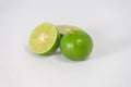 Fresh ripe green limes with sliced on white canvas background Royalty Free Stock Photo