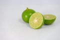 Fresh ripe green limes with sliced on white canvas background Royalty Free Stock Photo