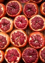 Fresh ripe half cut pomegranates on wooden background.