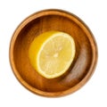 Fresh and ripe half lemon, yellow citrus fruit in wooden bowl