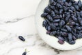 Fresh ripe honeysuckle berries in a ceramic bowl Royalty Free Stock Photo