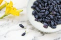 Fresh ripe honeysuckle berries in a ceramic bowl Royalty Free Stock Photo