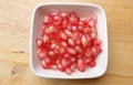 fresh ripe juicy grains Pomegranate, (Punica granatum) seeds in the square bowl