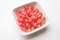 fresh ripe juicy grains Pomegranate, (Punica granatum) seeds in the square bowl