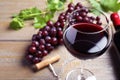 Fresh ripe juicy grapes and glass of  on wooden table, closeup Royalty Free Stock Photo