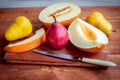 Fresh ripe juicy melon slices and pears on the table Royalty Free Stock Photo