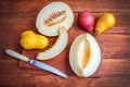 Fresh ripe juicy melon slices and plums on the table Royalty Free Stock Photo