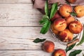 Fresh ripe juicy peaches on white wooden table, flat lay. Space for text Royalty Free Stock Photo
