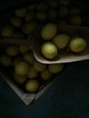 Fresh ripe lemons on dark stone background. Top view with copy s