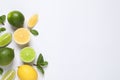 Fresh ripe lemons, limes and mint leaves on white background, top view Royalty Free Stock Photo