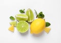 Fresh ripe lemons, limes and mint leaves on white background, top view Royalty Free Stock Photo