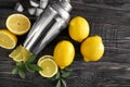 Fresh ripe lemons with shaker on wooden table Royalty Free Stock Photo