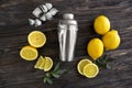 Fresh ripe lemons with shaker on wooden table Royalty Free Stock Photo