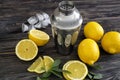 Fresh ripe lemons with shaker on wooden table Royalty Free Stock Photo
