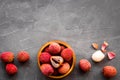 Fresh ripe lychee in bowl on grey desk top-down frame copy space Royalty Free Stock Photo