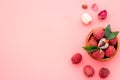 Fresh ripe lychee in bowl on pink desk top-down frame copy space Royalty Free Stock Photo