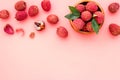 Fresh ripe lychee in bowl on pink desk top-down frame copy space Royalty Free Stock Photo