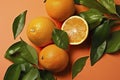 Fresh ripe mandarins, grapefruit and oranges with green leaves on orange background