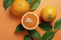 Fresh ripe mandarins, grapefruit and oranges with green leaves on orange background