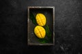 Fresh ripe mango on black stone background. Tropical fruits. Top view. Royalty Free Stock Photo