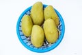 Fresh ripe mangoes in blue basket