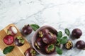 Fresh ripe mangosteen fruits on white marble table, flat lay. Space for text