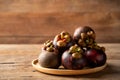 Fresh ripe mangosteen fruits on wooden plate.queen of fruit in Thailand Royalty Free Stock Photo