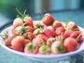 Fresh ripe natural strawberry, red and white fruit on glass table