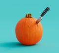 Fresh ripe orange pumpkin with kitchen knife ready for carving Royalty Free Stock Photo