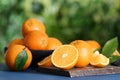 Fresh ripe oranges on blue wooden table against blurred background. Space for text Royalty Free Stock Photo