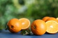 Fresh ripe oranges on blue wooden table against blurred background. Space for text Royalty Free Stock Photo