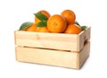 Fresh ripe oranges with green leaves in wooden crate on white background Royalty Free Stock Photo