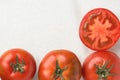 Fresh Ripe Organic Red Tomatoes Whole Halved on White Marble Stone. Italian Spanish Greek Mediterranean Cuisine Royalty Free Stock Photo