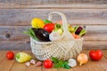 Fresh ripe organic vegetables in a wicker basket on a wooden table Royalty Free Stock Photo