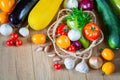 Fresh ripe organic vegetables in a wicker plate on a wooden table Royalty Free Stock Photo