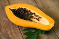 Fresh ripe papaya tropical fruit with papaya seed and leaf leaves from papaya tree, papaya fruits on wooden background Royalty Free Stock Photo