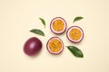 Fresh ripe passion fruits maracuyas with leaves on beige background