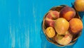 Fresh ripe peaches, pears and apricots in a plate on a blue wooden background. Fresh fruit background. Summer fruits Royalty Free Stock Photo