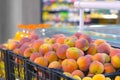 Fresh ripe peaches in plastic box ready for sale in supermarket, closeup view. Royalty Free Stock Photo