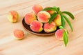 Fresh ripe peaches in a plate on a wooden table Royalty Free Stock Photo