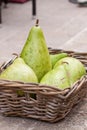 Fresh ripe pears in a wicker basket