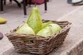 Fresh ripe pears in a wicker basket