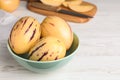 Fresh ripe pepino melons in bowl on white table. Space for text Royalty Free Stock Photo