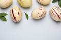 Fresh ripe pepino melons and green leaves on white background, flat lay. Space for text Royalty Free Stock Photo