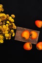 Fresh ripe persimmon on a black background . Persimmons fruit, Ripe sweet persimmons Royalty Free Stock Photo