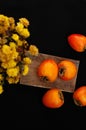 Fresh ripe persimmon on a black background . Persimmons fruit, Ripe sweet persimmons Royalty Free Stock Photo