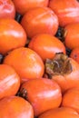 Fresh ripe persimmons placed on table in market Royalty Free Stock Photo