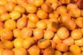 Fresh ripe persimmons placed on table in market. Royalty Free Stock Photo