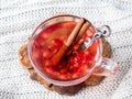Fresh ripe pomegranate and red wine in a glass mug on a white knitted blanket Royalty Free Stock Photo